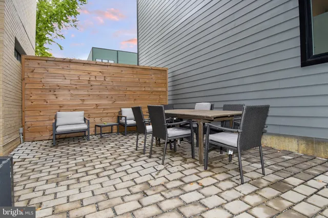 a backyard of a house with table and chairs