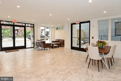 a living room with furniture and large windows