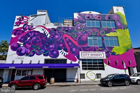 a front view of two building with parking space