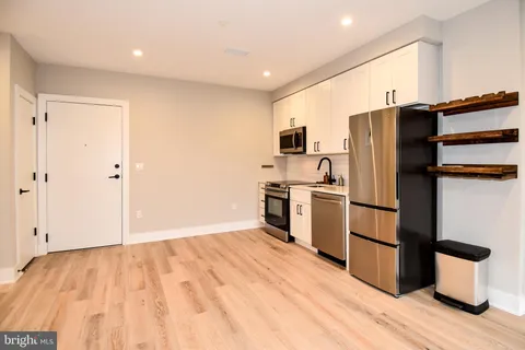 a kitchen with stainless steel appliances a refrigerator and a stove top oven