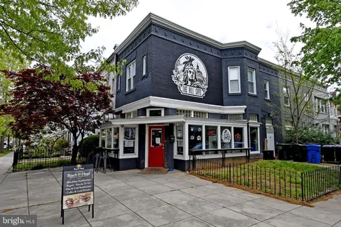 a view of city with the shops and cars
