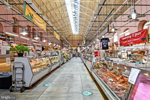 a group of people sitting in front of a store