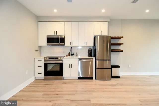 a kitchen with stainless steel appliances a refrigerator stove and microwave