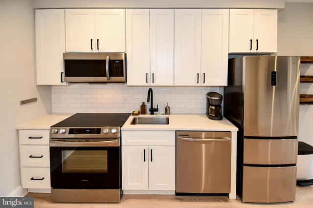 a kitchen with a stove microwave and refrigerator
