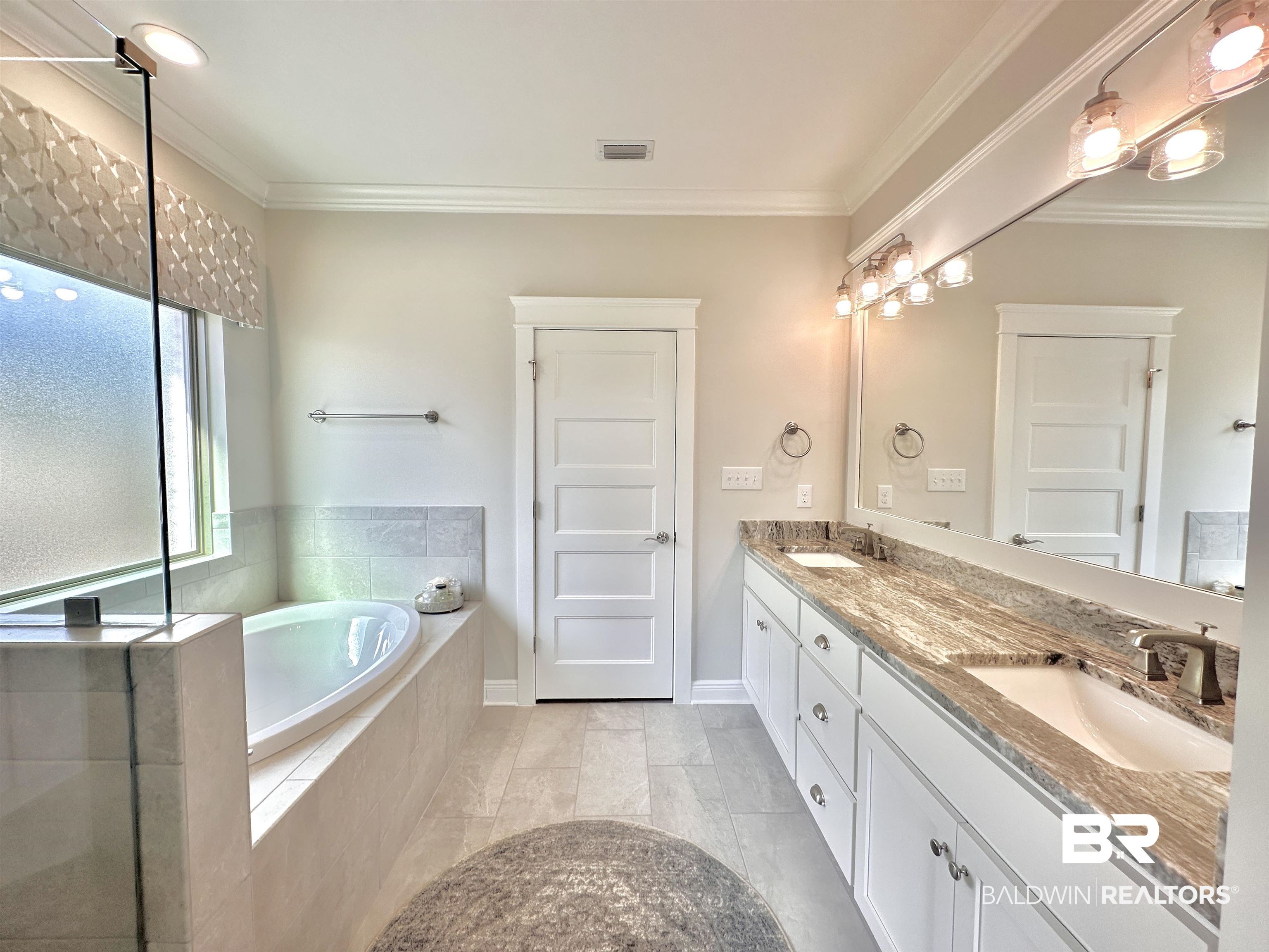 691 Kitfox Avenue Fairhope, AL 36532 - Photo 13 of 42 Bathroom featuring vanity, crown molding, and tiled bath
