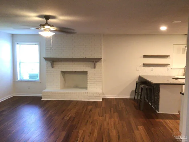 a kitchen with kitchen island granite countertop a sink appliances and cabinets