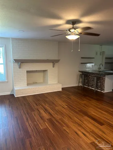 a view of kitchen with sink microwave and refrigerator