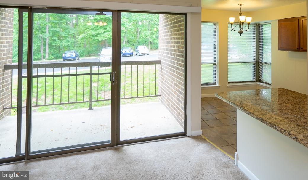 11216 Chestnut Grove Square, Unit 119 Reston, VA 20190 - Photo 7 of 16 Living Room w/Sliding Door to Patio