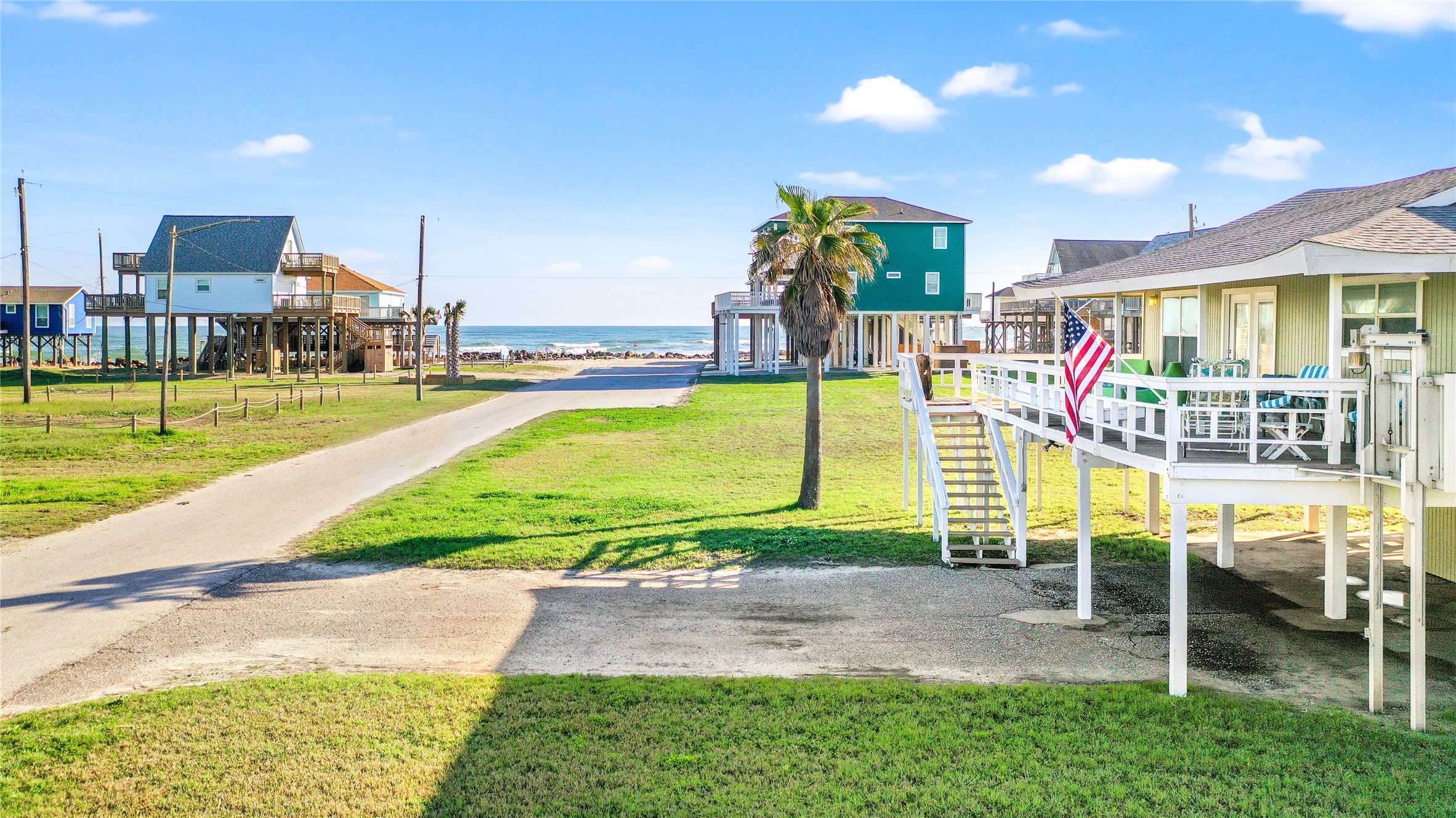 12911 Jolly Roger Drive Freeport, TX 77541 - Photo 2 of 41 a view of a swimming pool with a yard and lawn chairs