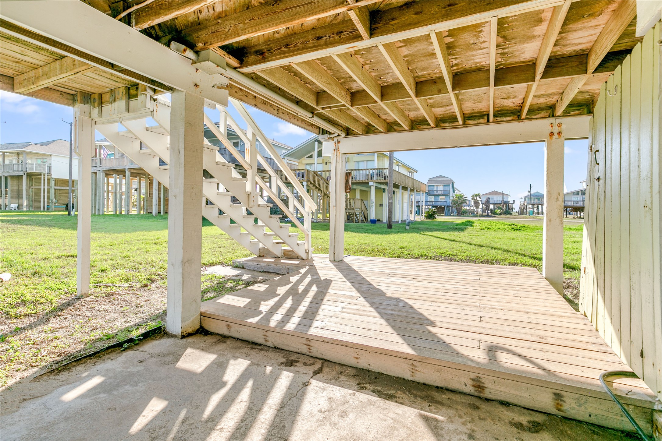 12911 Jolly Roger Drive Freeport, TX 77541 - Photo 33 of 41 a view of a porch with wooden floor and stairs