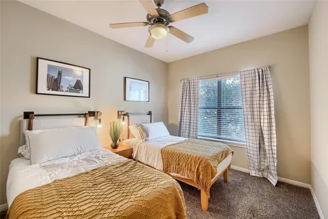 a bedroom with two beds and a chandelier