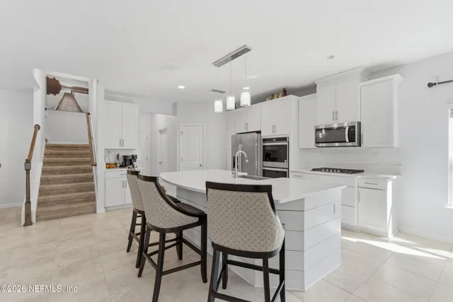a kitchen with stainless steel appliances a sink stove and refrigerator