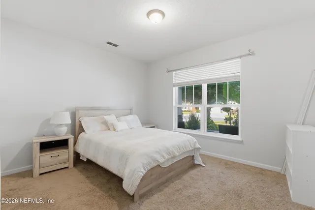 a living room with furniture a pool table and a couch