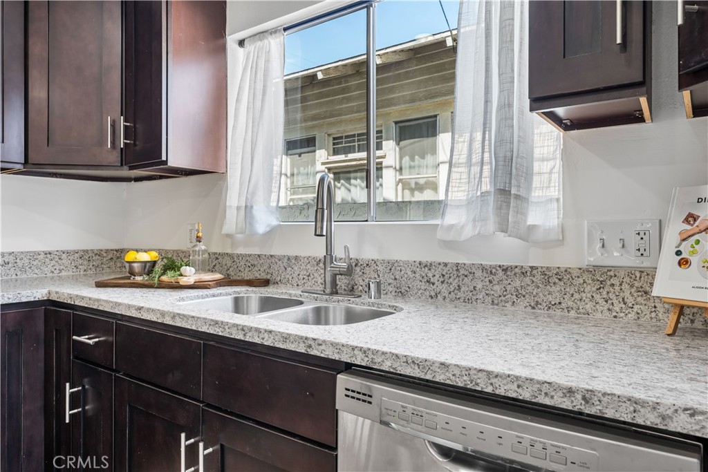 1178 Spence Street Los Angeles, CA 90023 - Photo 11 of 36 a kitchen with granite countertop a sink a stove and cabinets