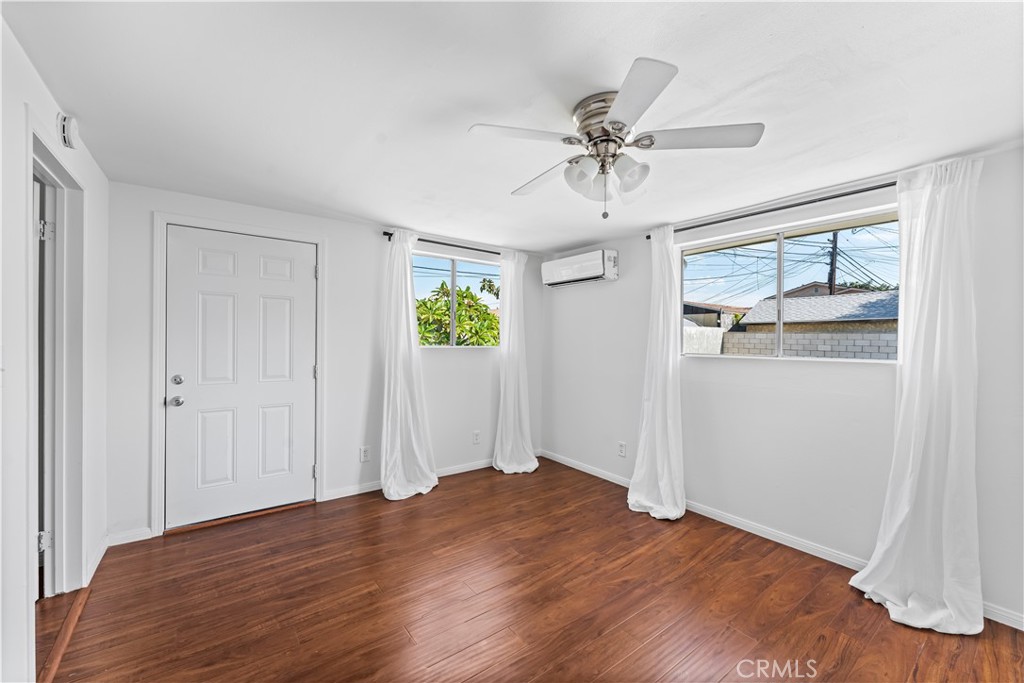 1178 Spence Street Los Angeles, CA 90023 - Photo 15 of 36 a view of empty room with wooden floor and window