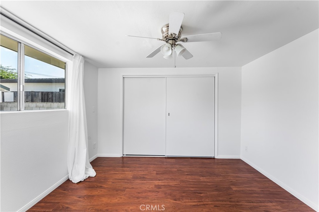 1178 Spence Street Los Angeles, CA 90023 - Photo 16 of 36 a view of an empty room with wooden floor and a window