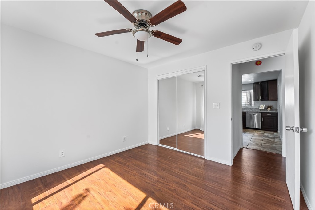 1178 Spence Street Los Angeles, CA 90023 - Photo 17 of 36 a view of empty room with wooden floor and ceiling fan