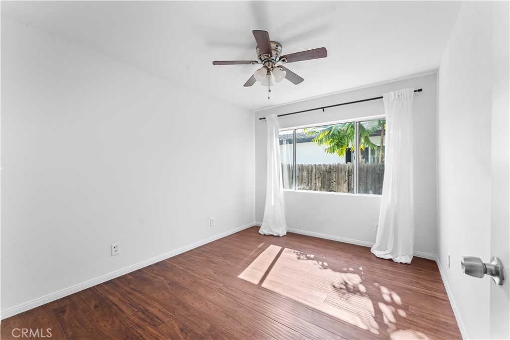 1178 Spence Street Los Angeles, CA 90023 - Photo 18 of 36 a view of empty room with wooden floor and fan