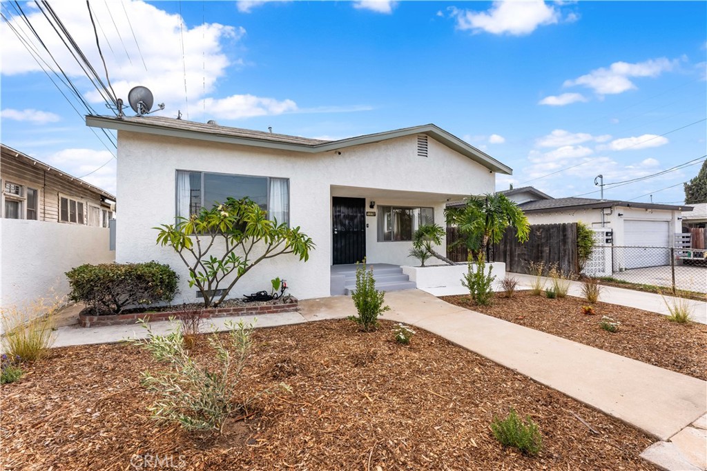 1178 Spence Street Los Angeles, CA 90023 - Photo 2 of 36 a view of a house with backyard porch and sitting area