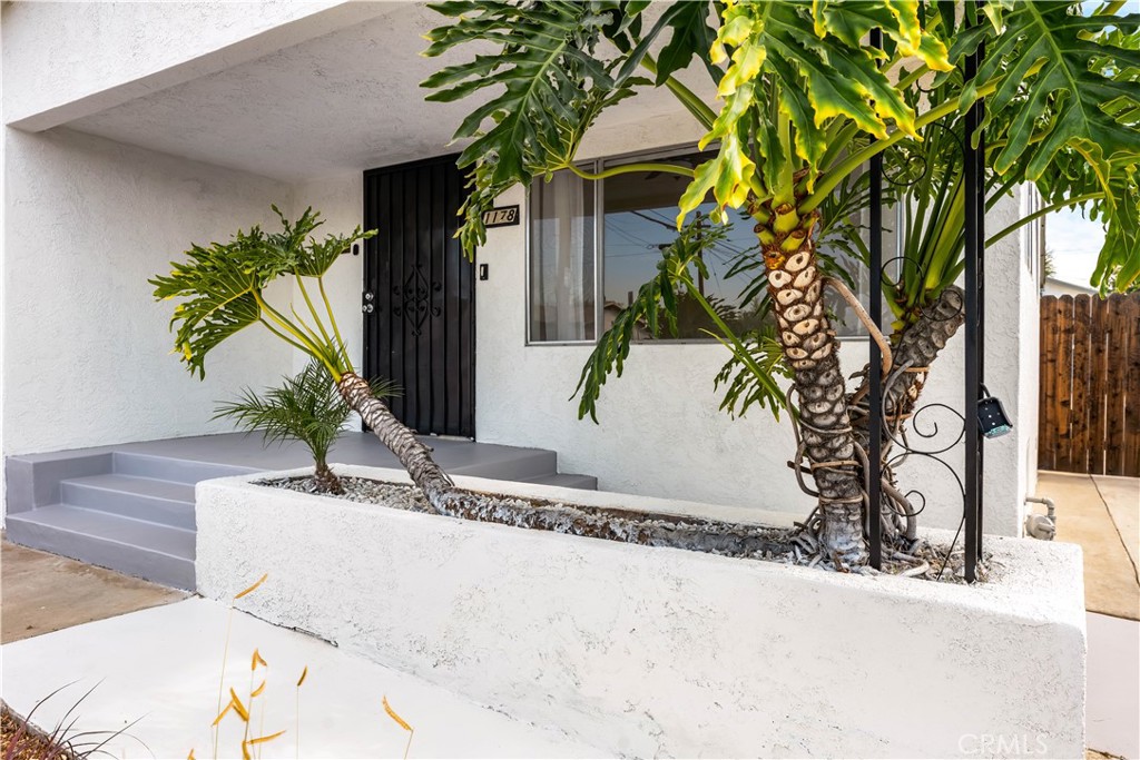 1178 Spence Street Los Angeles, CA 90023 - Photo 25 of 36 a potted plant sitting in front of a house