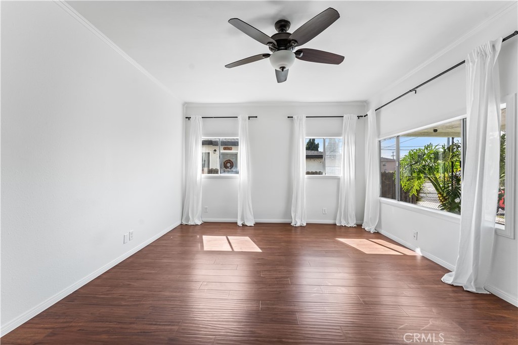 1178 Spence Street Los Angeles, CA 90023 - Photo 3 of 36 a view of an empty room with wooden floor and a window