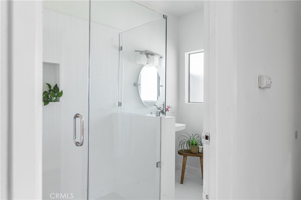 1178 Spence Street Los Angeles, CA 90023 - Photo 32 of 36 a bathroom with a glass shower door