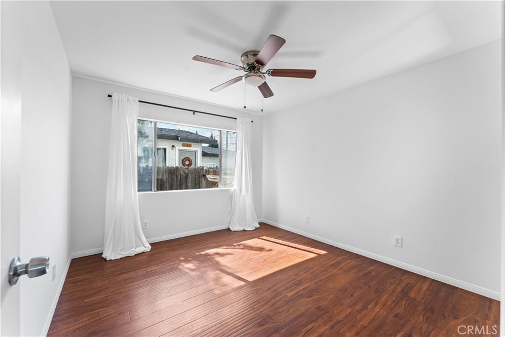 1178 Spence Street Los Angeles, CA 90023 - Photo 35 of 36 wooden floor in an empty room with a window