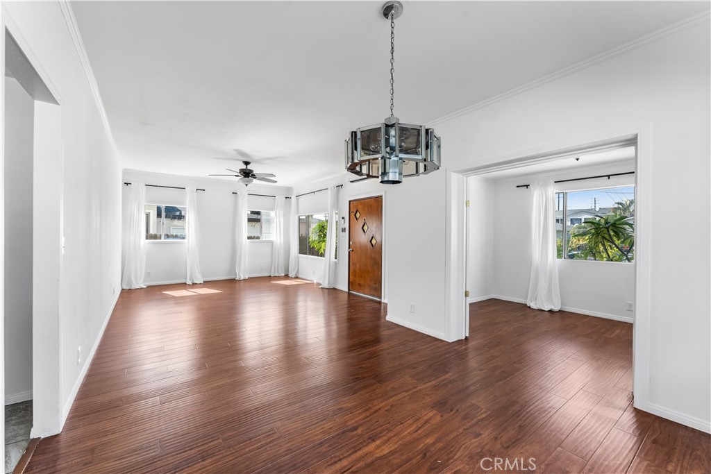 1178 Spence Street Los Angeles, CA 90023 - Photo 4 of 36 a view of an empty room with wooden floor and a window