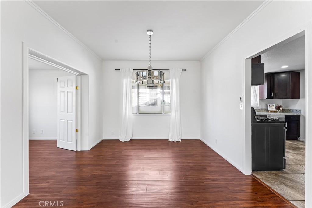 1178 Spence Street Los Angeles, CA 90023 - Photo 5 of 36 a view of an empty room with window and wooden floor