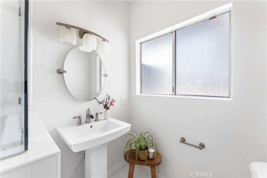 1178 Spence Street Los Angeles, CA 90023 - Photo 7 of 36 a bathroom with a sink a mirror and a toilet