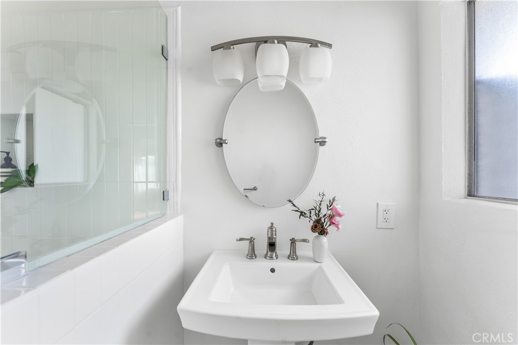 1178 Spence Street Los Angeles, CA 90023 - Photo 8 of 36 a bathroom with a sink and a mirror