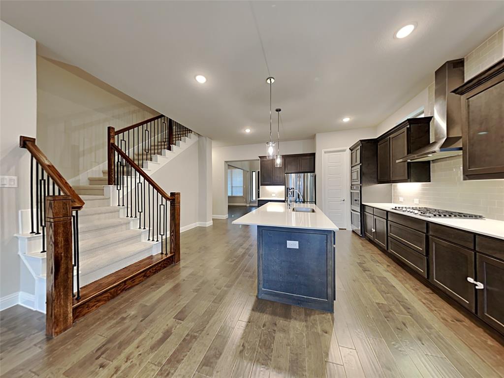 8262 Ottowa Ridge Frisco, TX 75034 - Photo 4 of 24 a view of kitchen with sink microwave and stove
