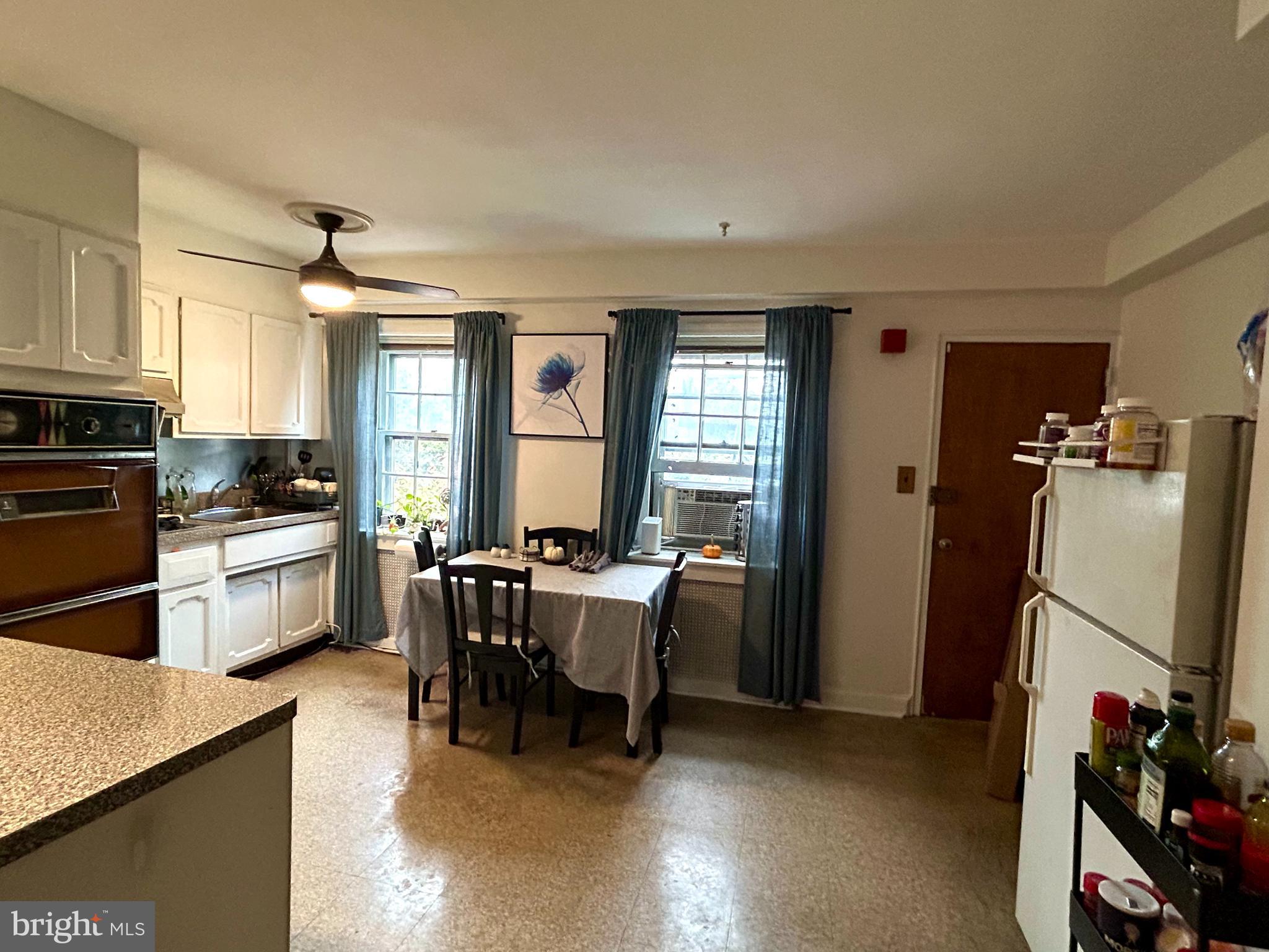 249 Pine Street, Unit 3 Philadelphia, PA 19106 - Photo 11 of 20 a kitchen with refrigerator and chairs