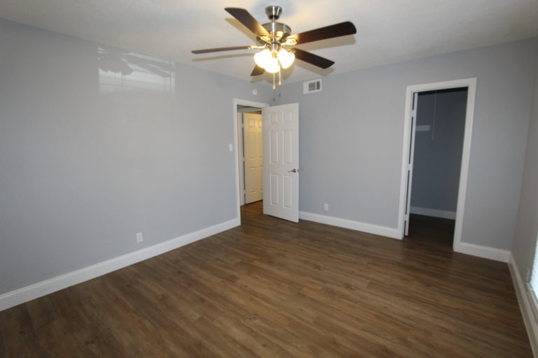6509 Berkman Drive, Unit 117 Austin, TX 78723 - Photo 13 of 16 a view of an empty room with window and wooden floor