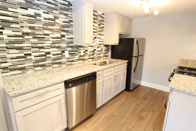 a kitchen with a sink stove and refrigerator