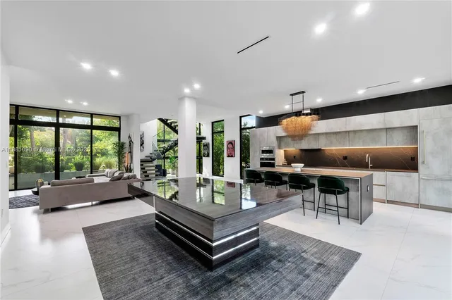 a living room with furniture a rug and a large window