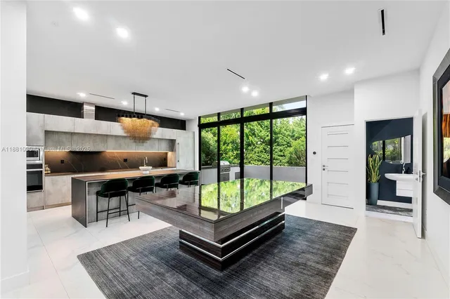 a living room with furniture a rug and a large window