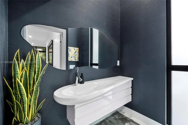 a bathroom with a sink a mirror and vanity