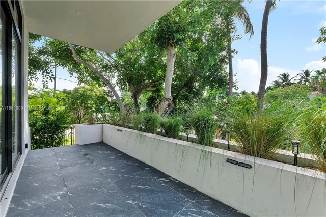a view of a green field with some trees in the background