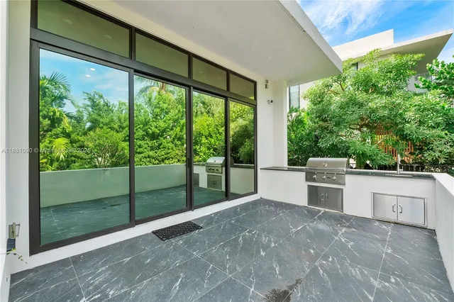 a view of a house with a plants and a tree