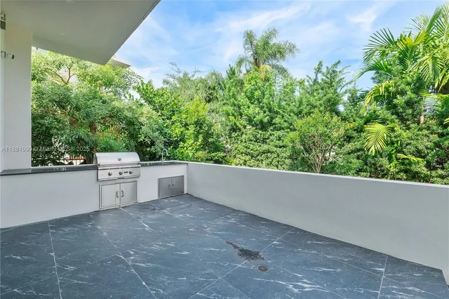 a view of backyard with a garden and trees