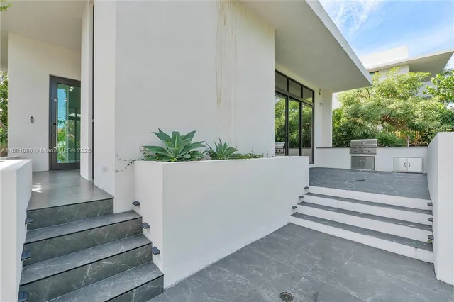 a view of a house with a small yard and plants