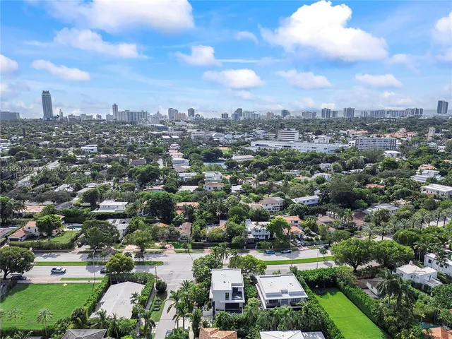 an aerial view of a house with garden space and street view