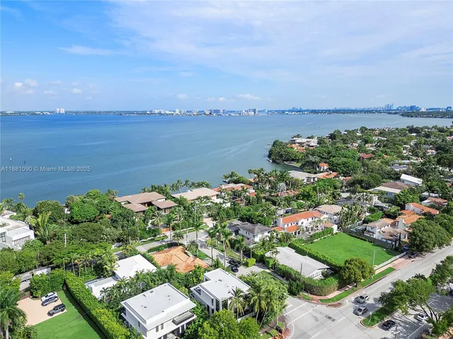 an aerial view of a house with a yard and lake view