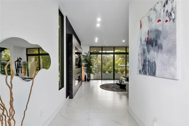 a view of hallway with furniture and a large window