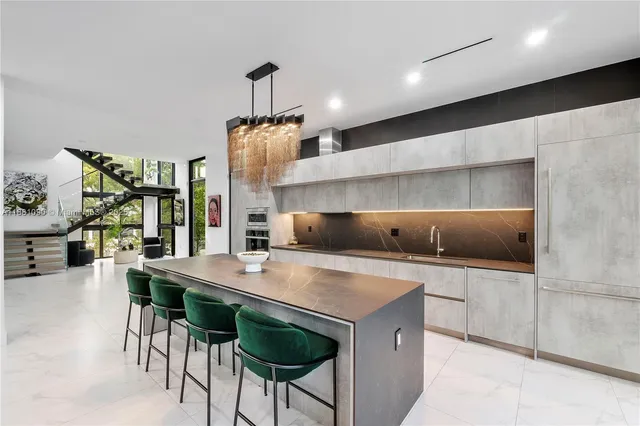 a kitchen with a table chairs sink and stove