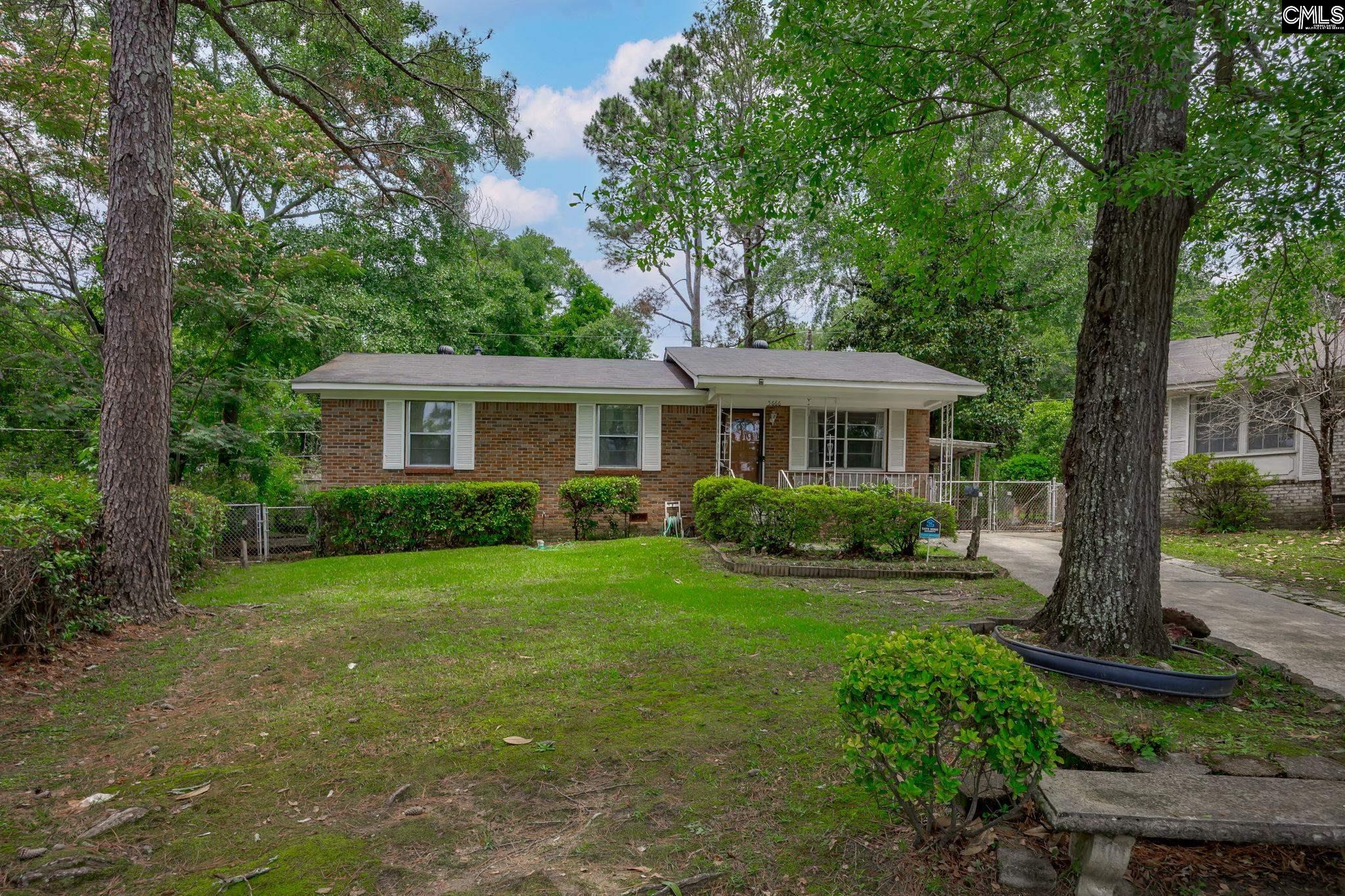 5666 Middleton Court Columbia, SC 29203 - Photo 1 of 42 a front view of a house with garden