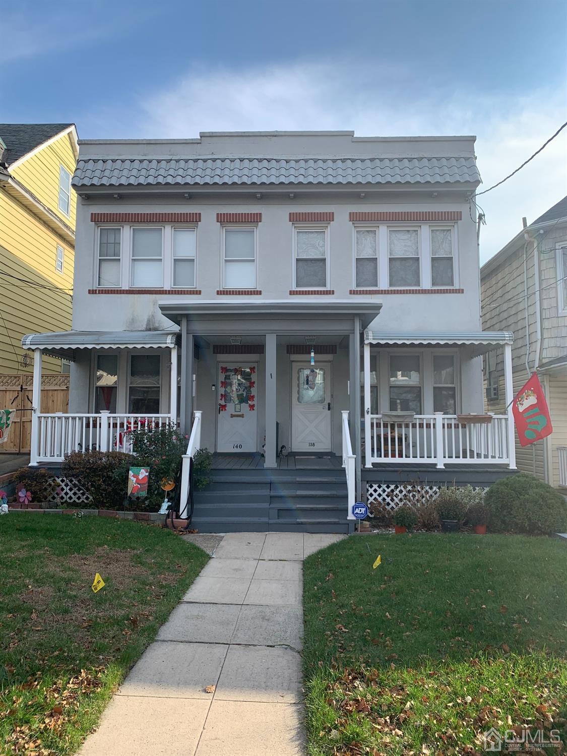 138 Rector Street Perth Amboy, NJ 08861 - Photo 1 of 15 a front view of a house with garden