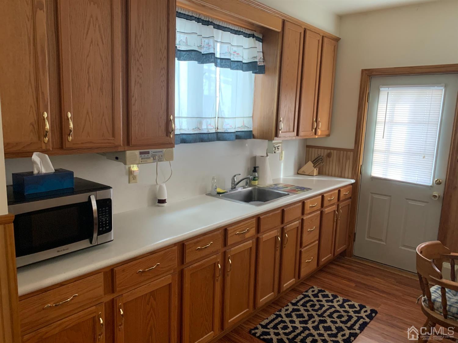 138 Rector Street Perth Amboy, NJ 08861 - Photo 15 of 15 a kitchen with stainless steel appliances a sink cabinets and wooden floor