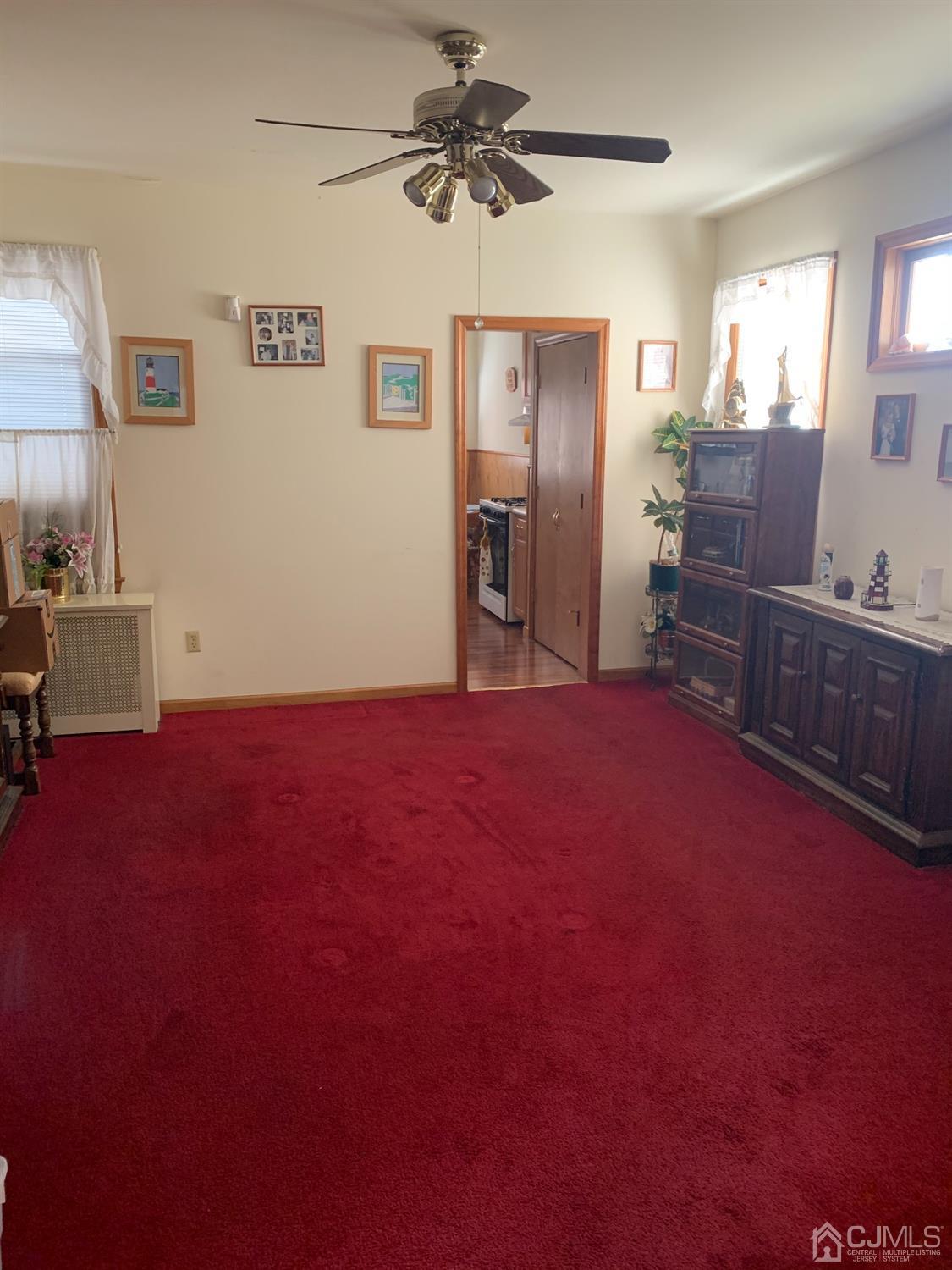 138 Rector Street Perth Amboy, NJ 08861 - Photo 5 of 15 a big room with windows and cabinet